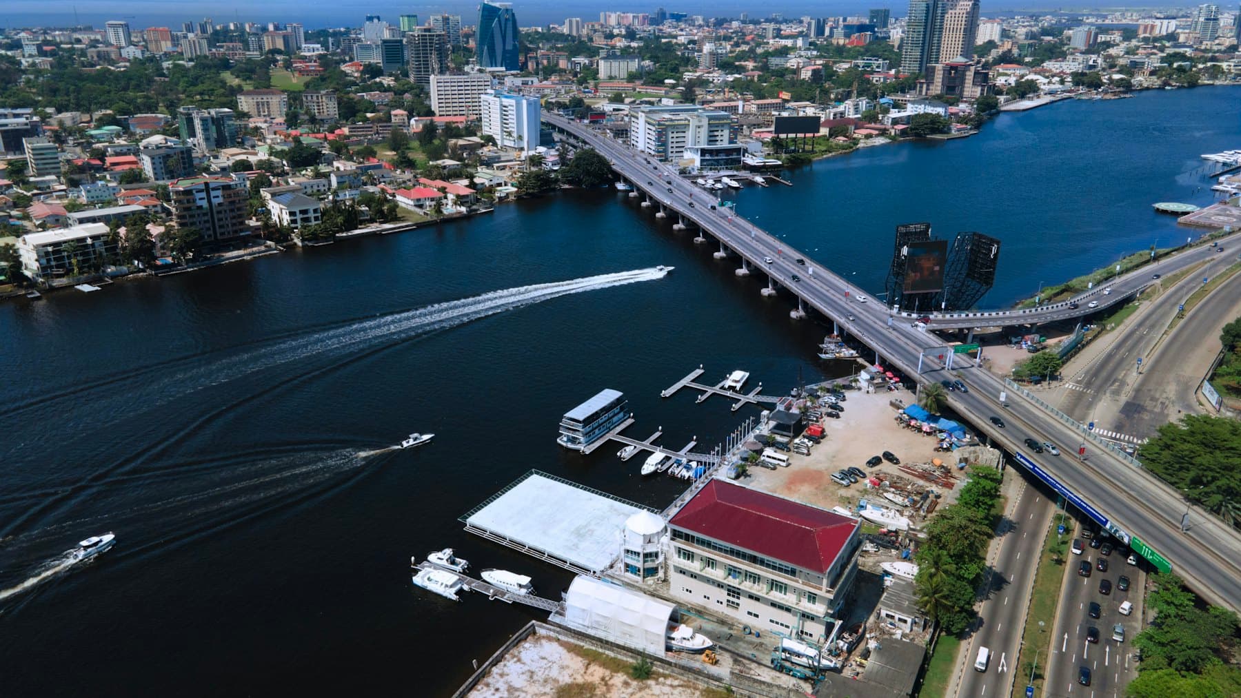 Aerial view of a waterfront city with a bridge crossing a lagoon