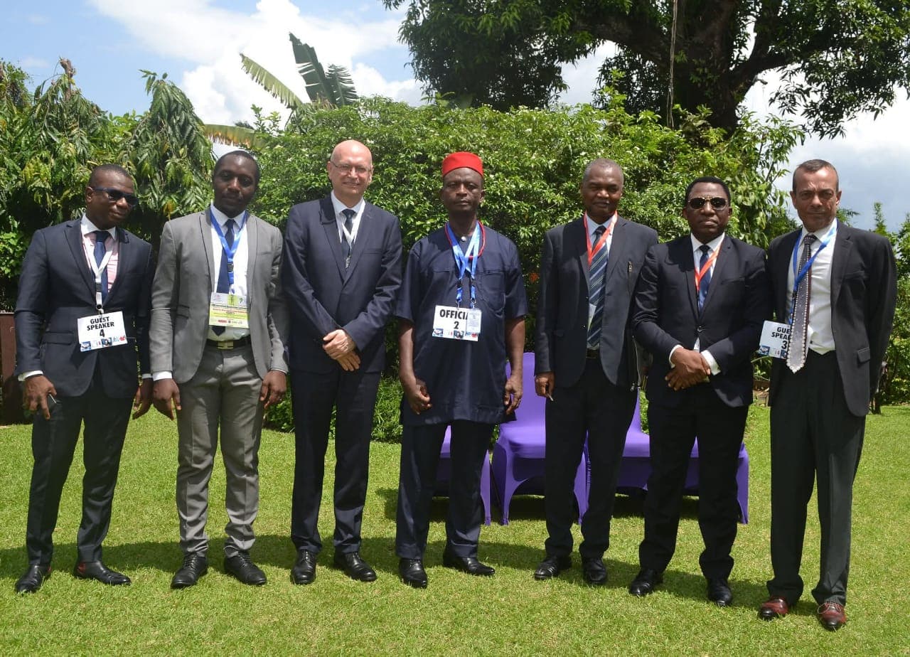 Guest speakers and officials at a WABS conference, standing together on a lawn